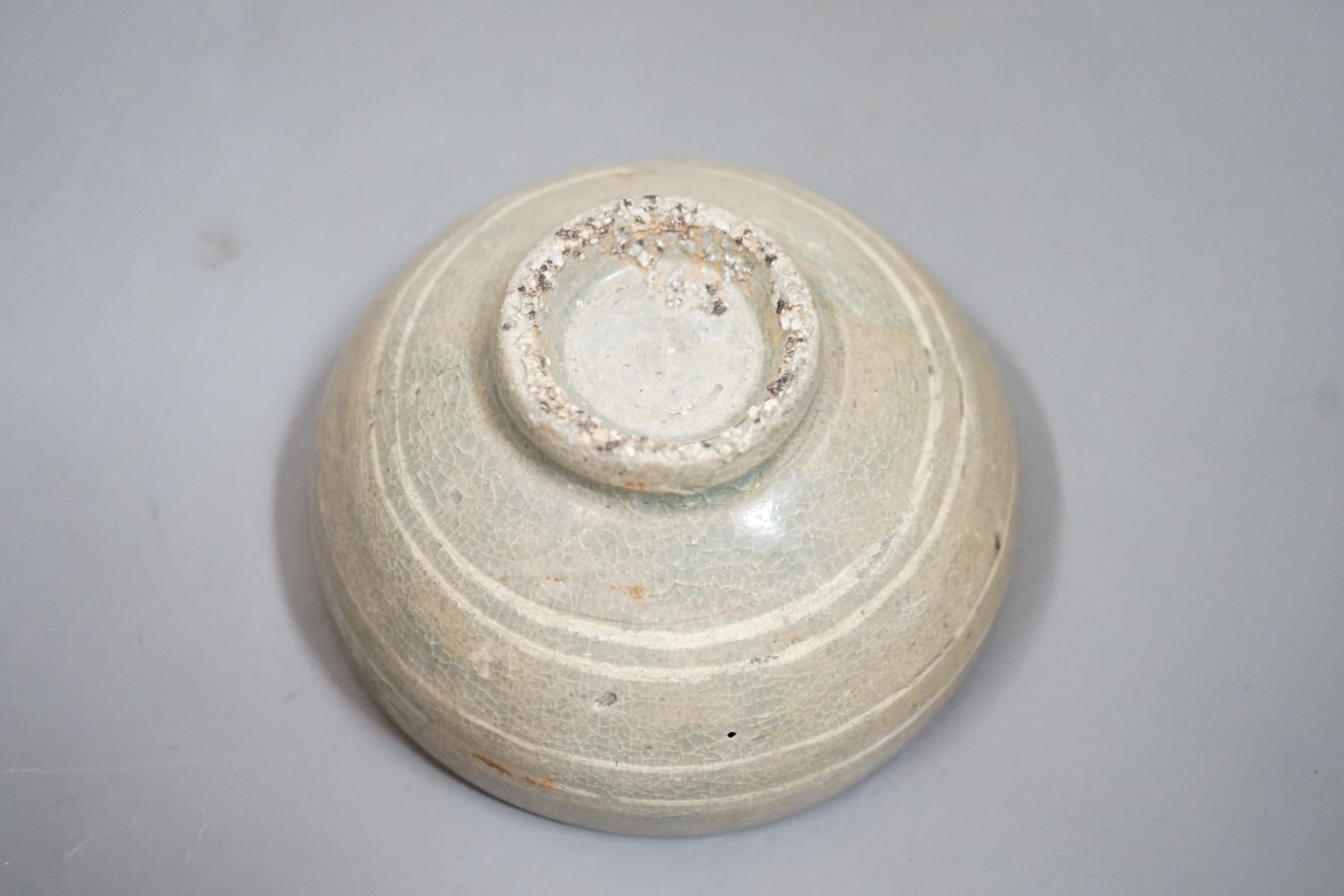 A Korean slip decorated celadon small bowl, Koryo dynasty. 10cm diameter